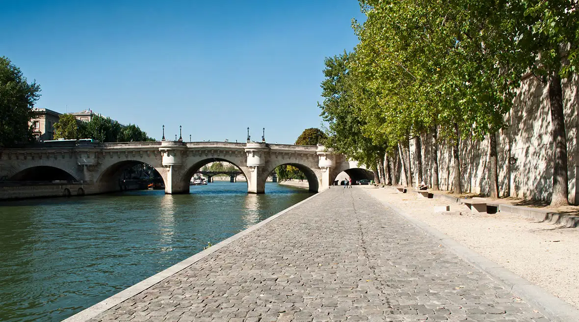 Seine river path with a bridge in the background