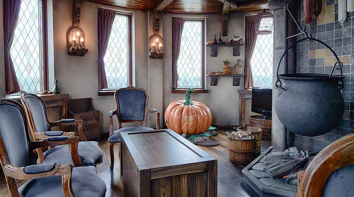 Cinderella themed hotel suite with a ceramic pumpkin and cauldron in the background