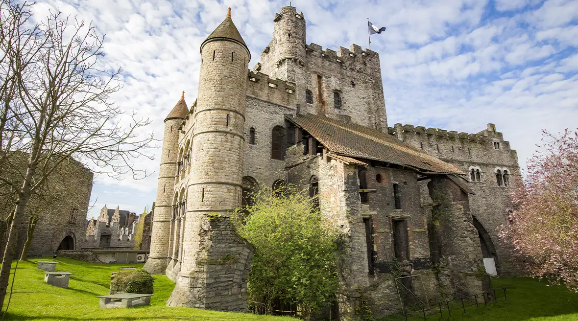 stone medieval castle against a sunny blue sky