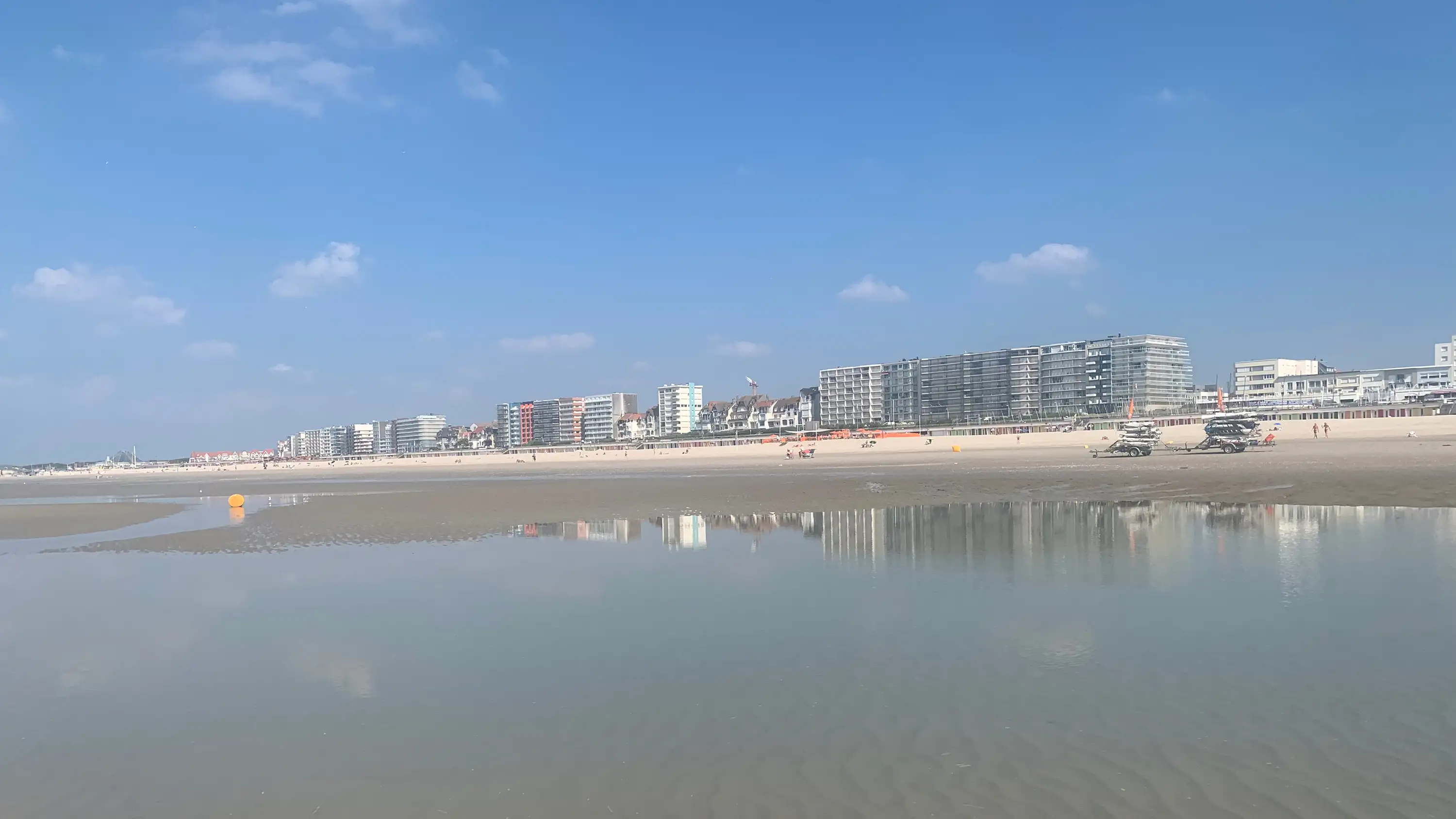 A view back at the seafront in Le Touquet, and its apartment buildings, from the beach at low tide