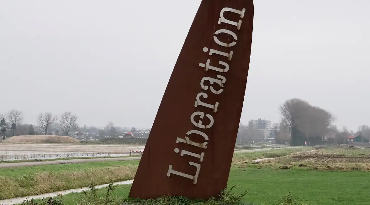An artwork imitation wing of a plane with the words ‘Liberation’ sticks into the ground