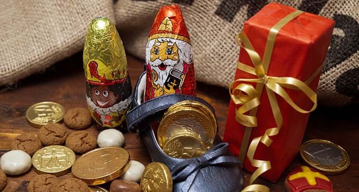 A small children’s shoe filled with gold Euro chocolate coins and gifts