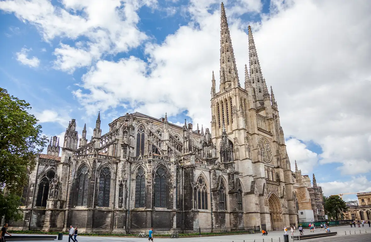 Exterior view of Cathédrale Saint-André de Bordeaux with its striking Gothic architecture and twin towers under a clear sky.