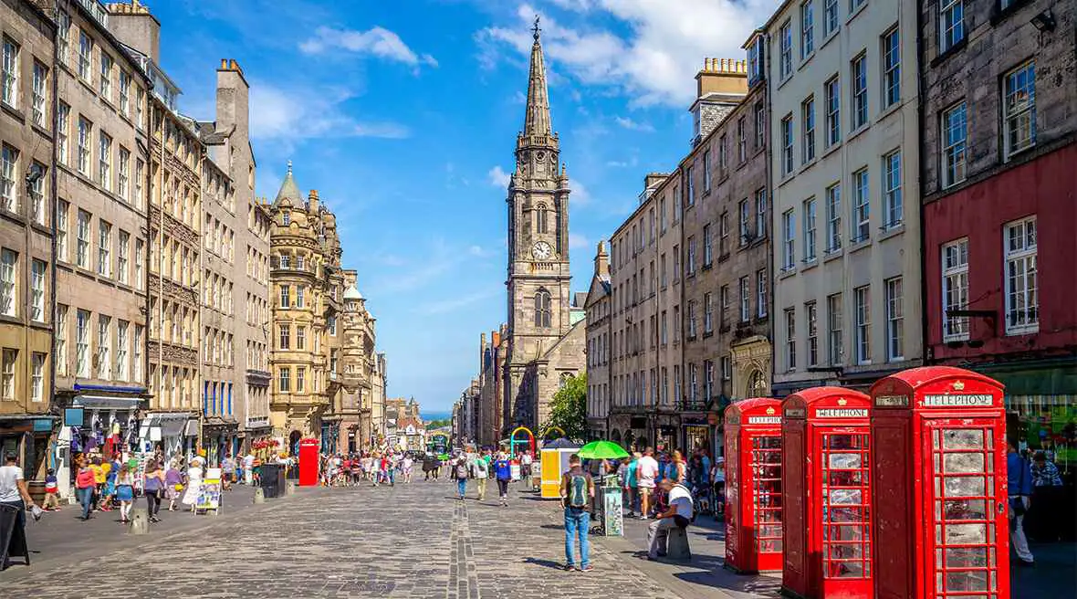 Die Royal Mile, gesäumt von historischen Gebäuden an einem sonnigen Tag.