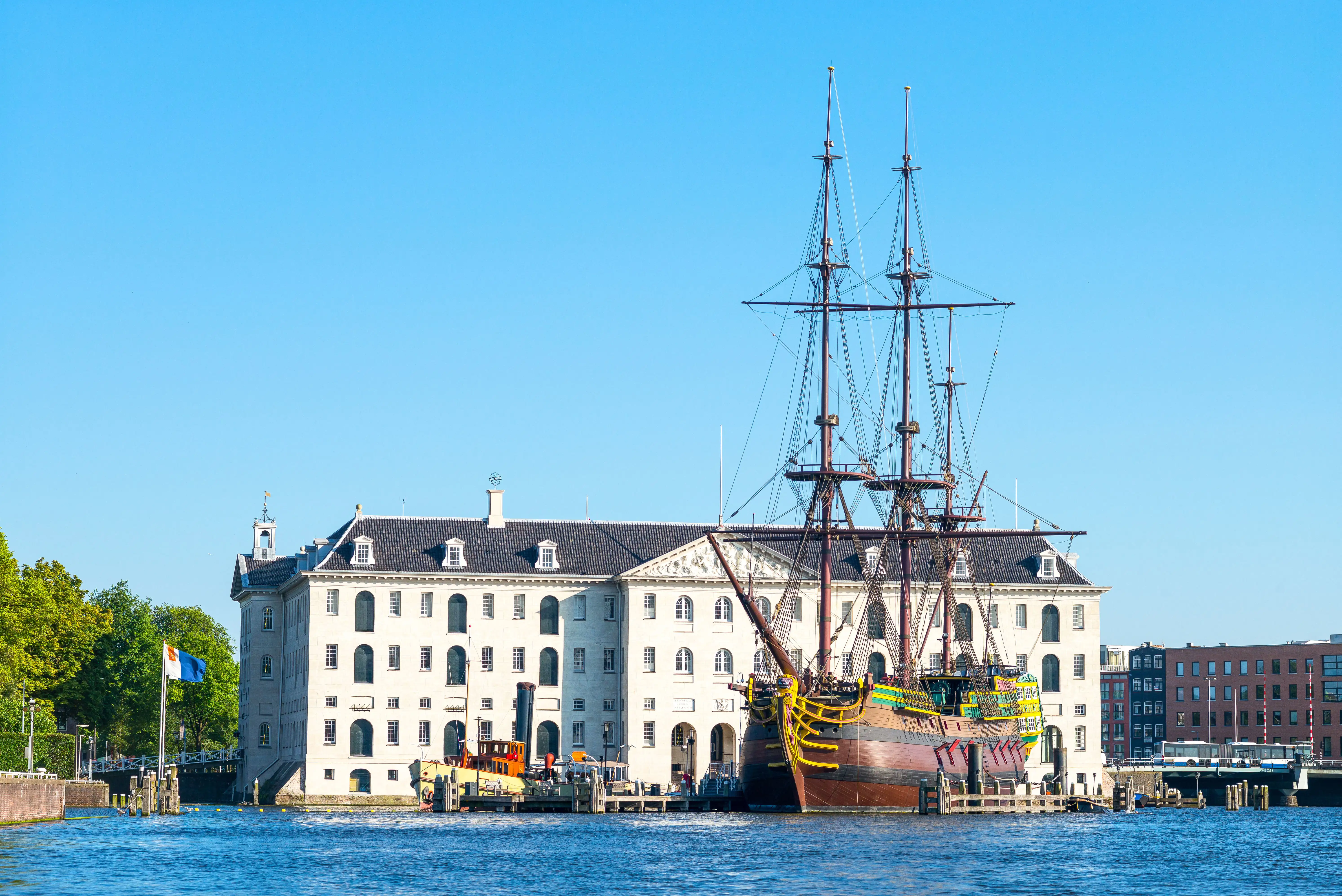 A historic ship moored in front of the National Maritime Museum, Amsterdam