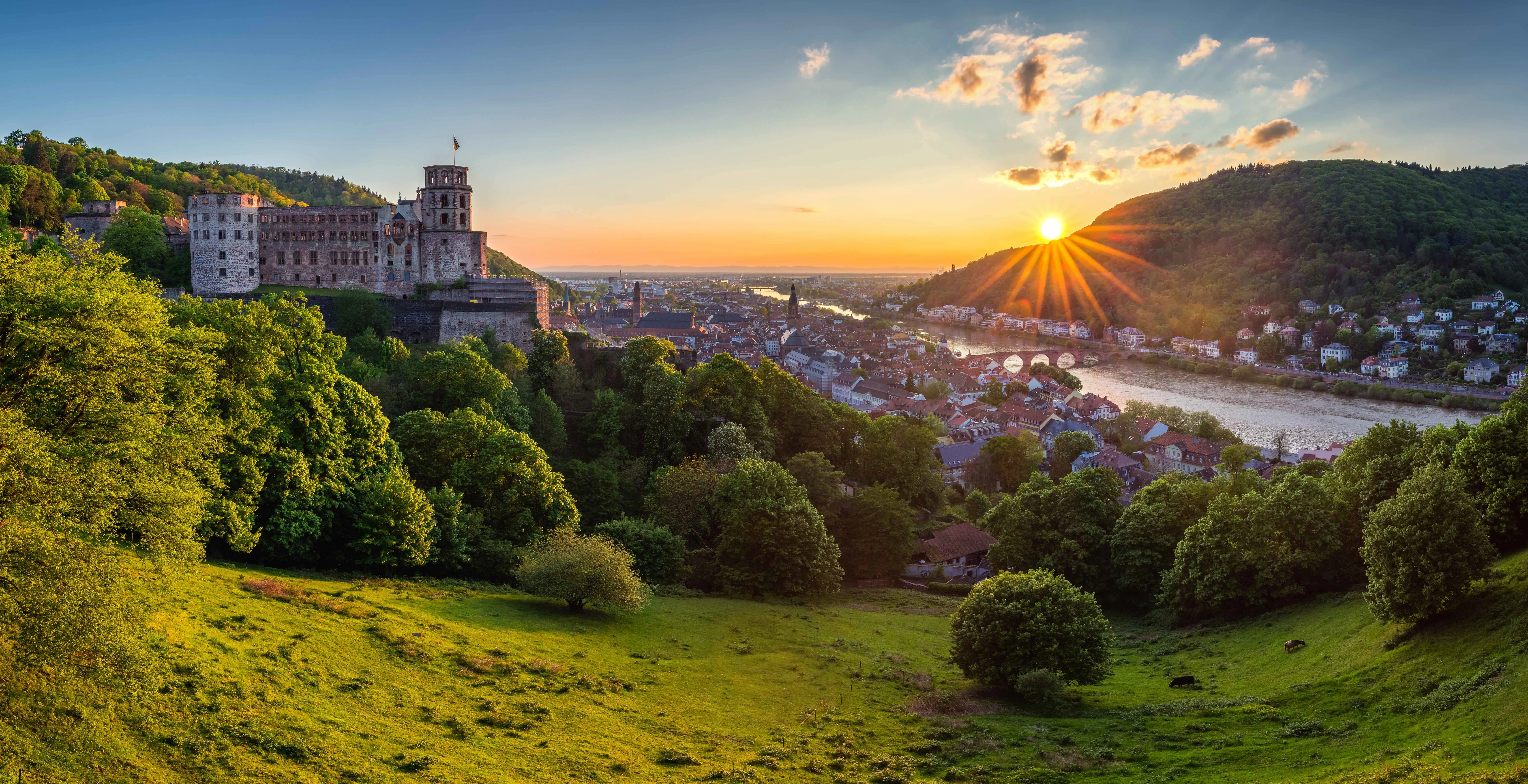 Heidelberg castle, with the city below, looking out over the Neckar river valley, at sunset