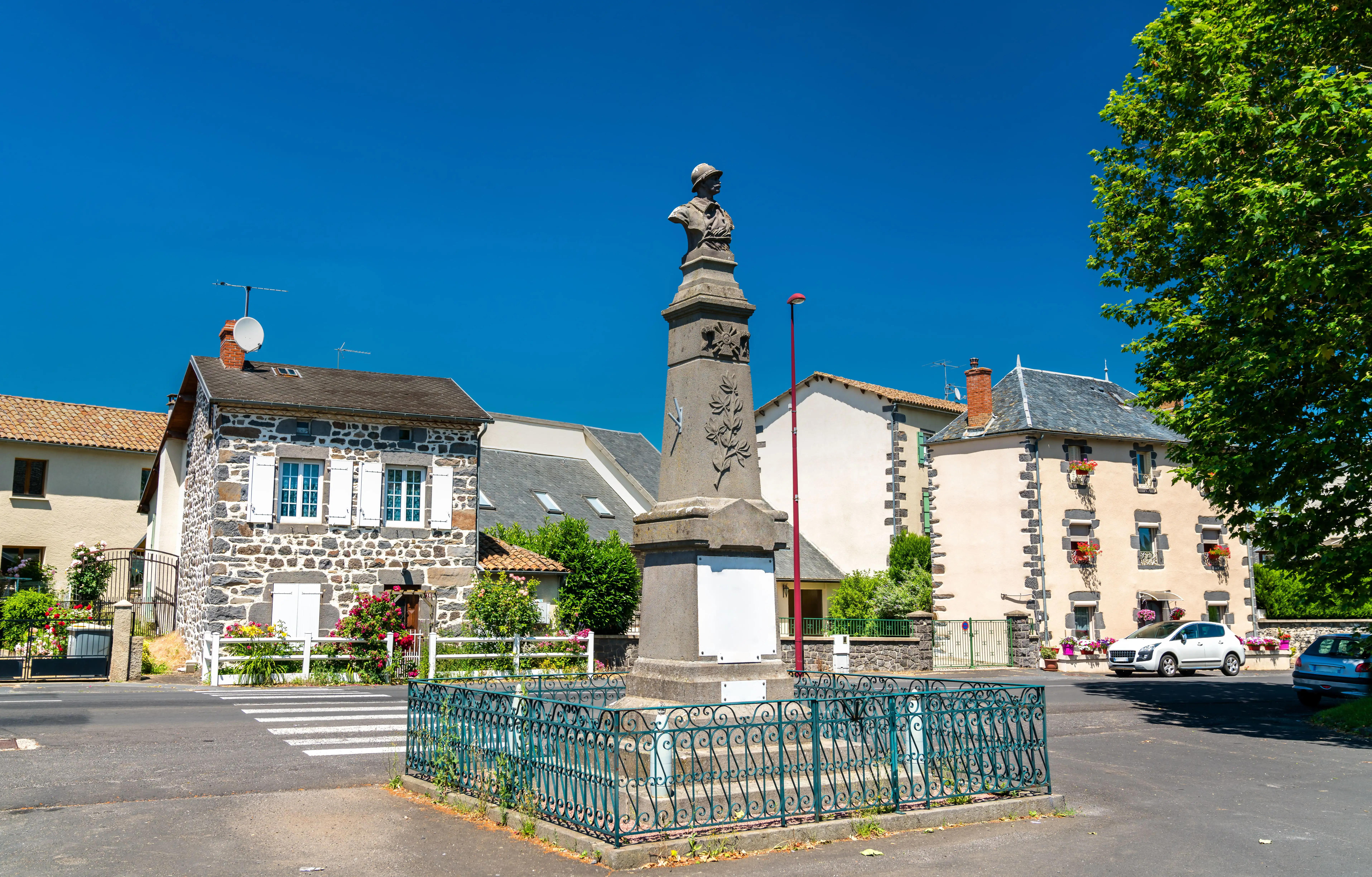 A war memorial in a French town on a summer’s day