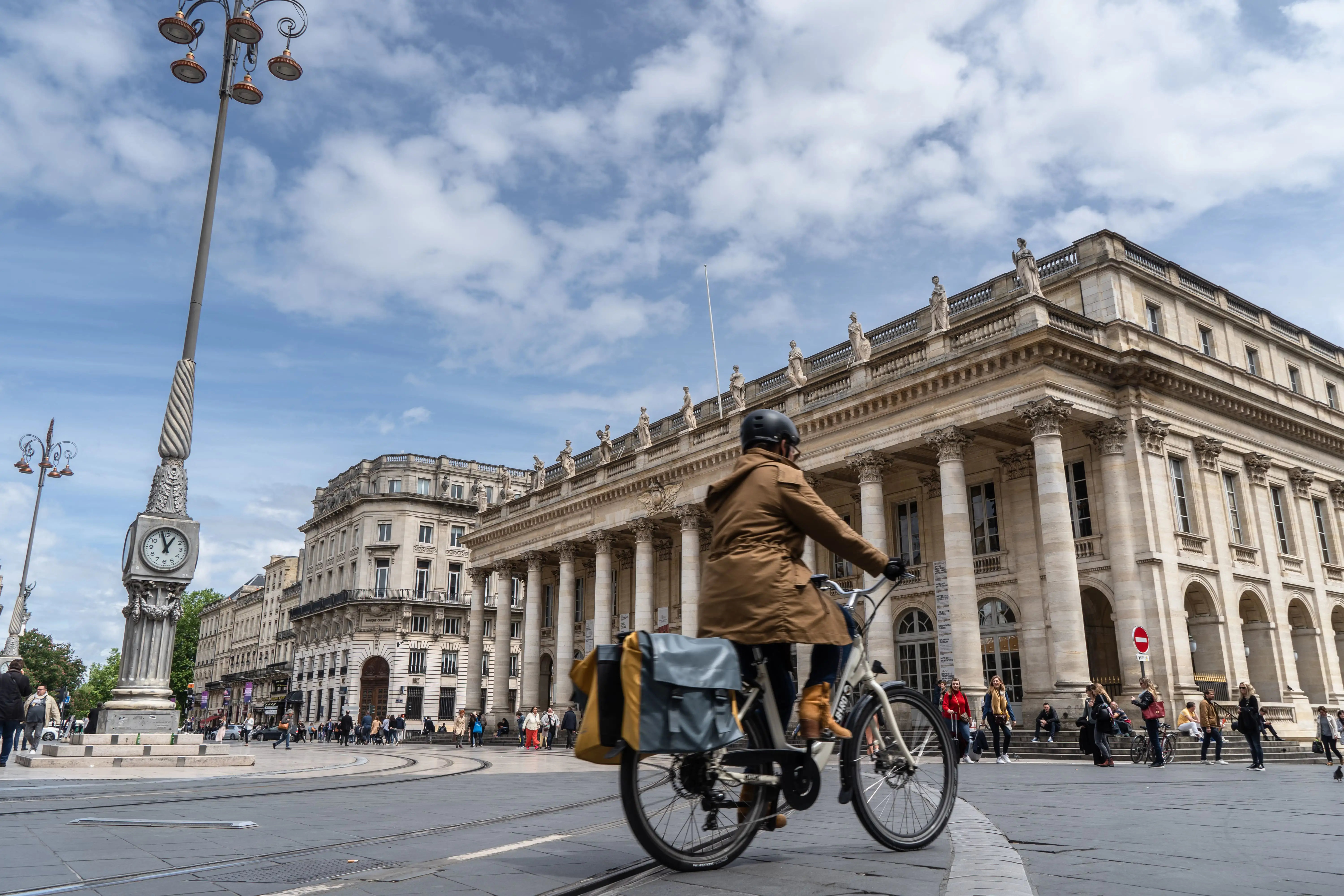 Cyclist riding in front of the Grand Theatre, Bordeaux