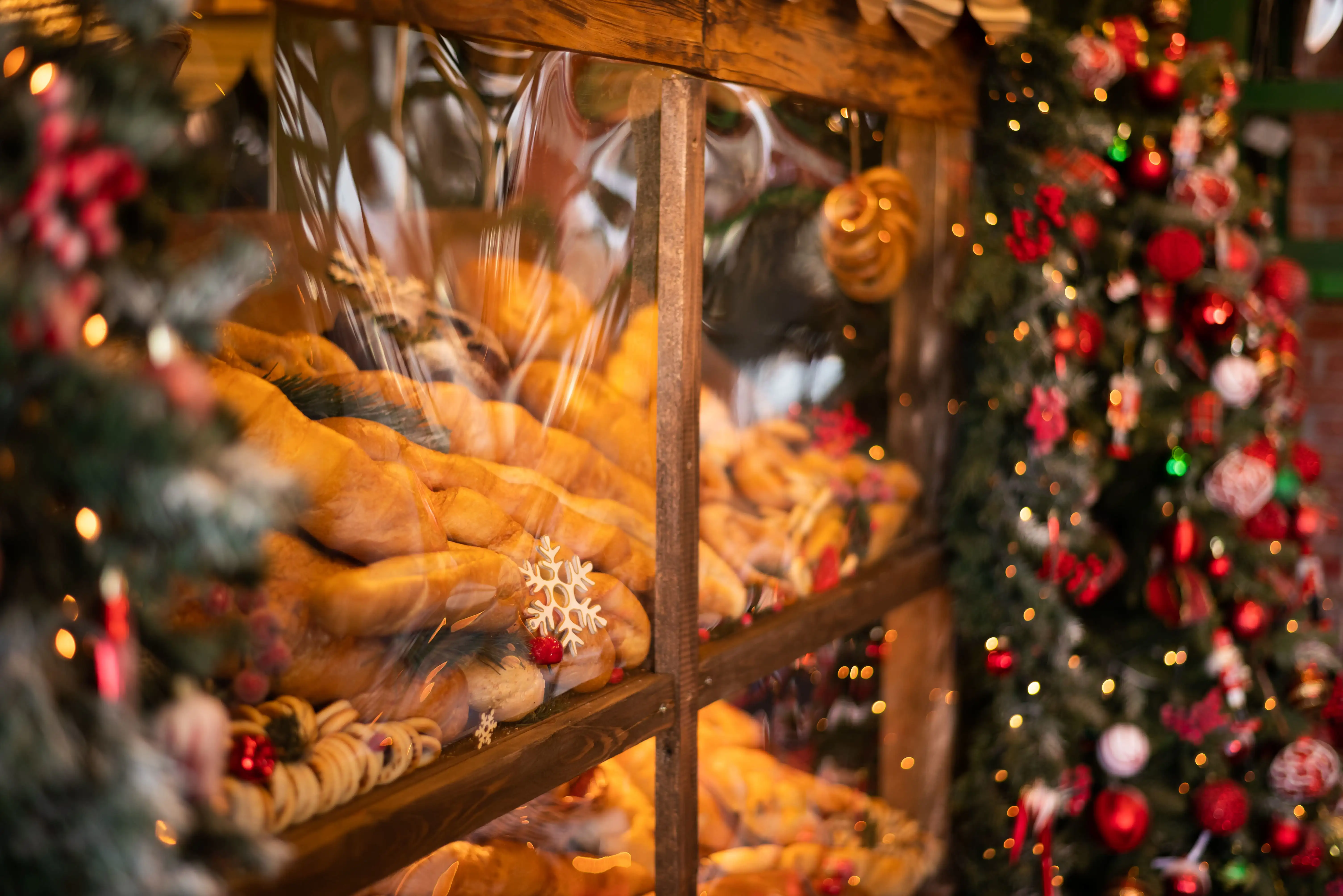 Freshly baked bread and rolls in a bakery window at Christmas