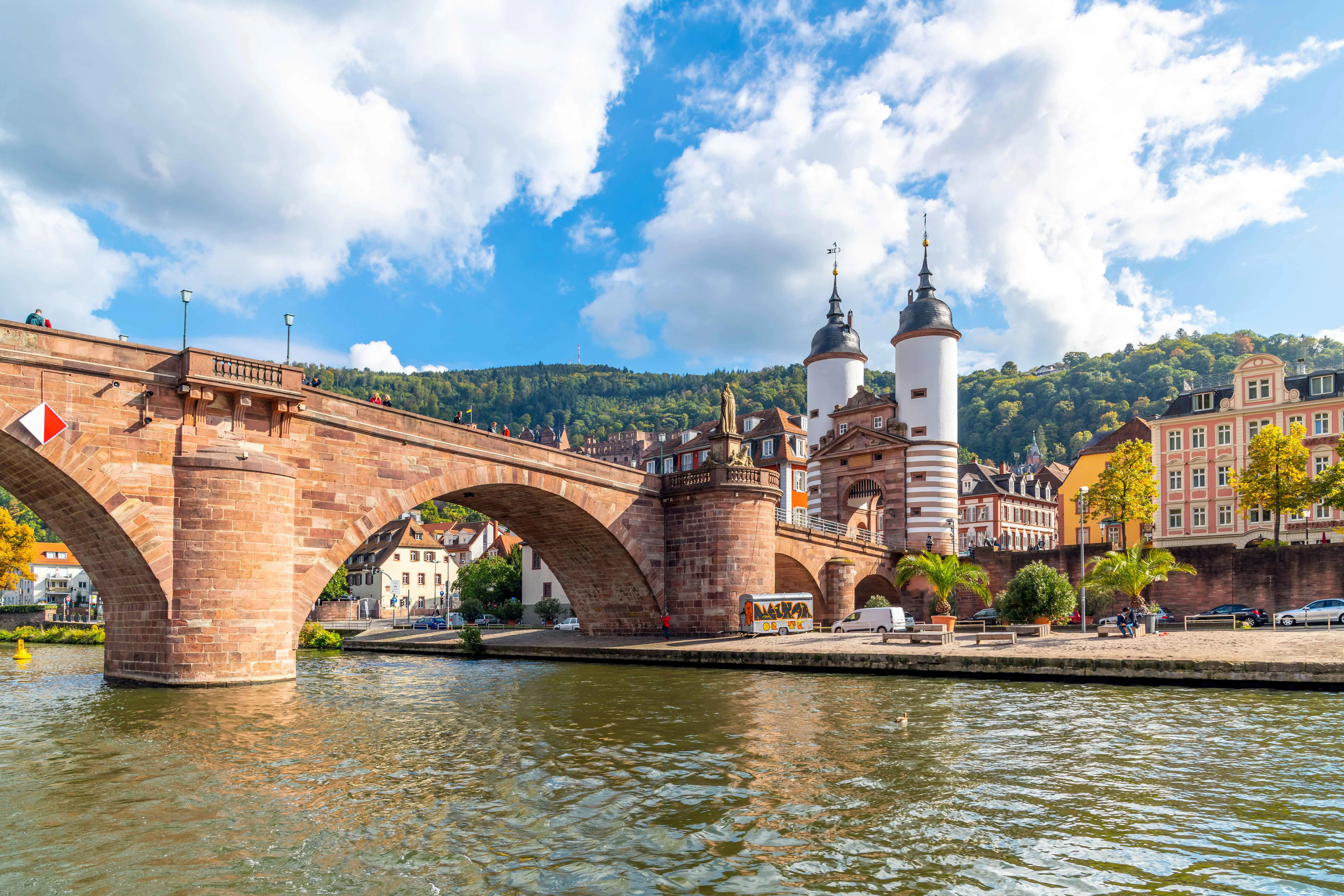 A stone bridge, the Karl Theodor Bridge, with romantic white gate towers, on the Neckar river in Heidelberg, Germany
