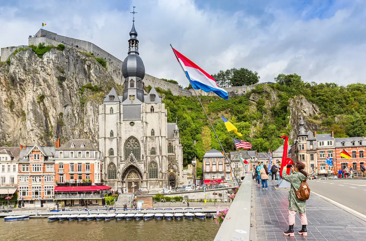 View of Dinant church from the bridge, with flags