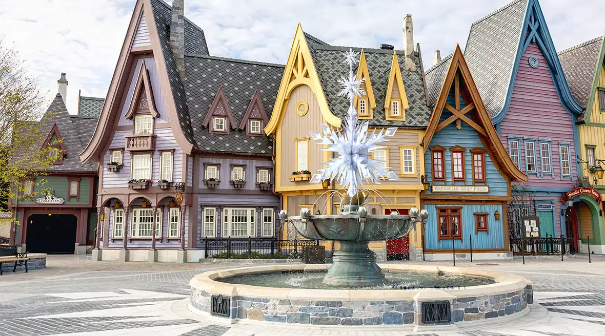 A centerpiece snowflake fountain anchors the immersive Nordic-inspired town within the new World of Frozen