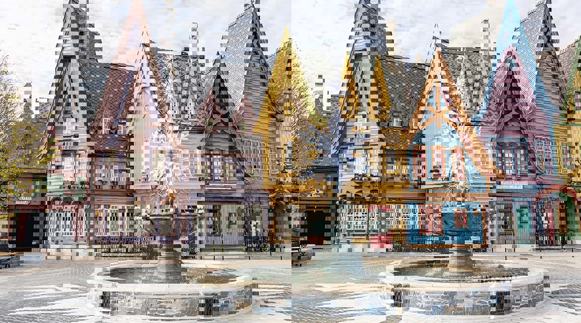 The town square of Arendelle featuring traditional Scandinavian-style architecture and the iconic snowflake fountain