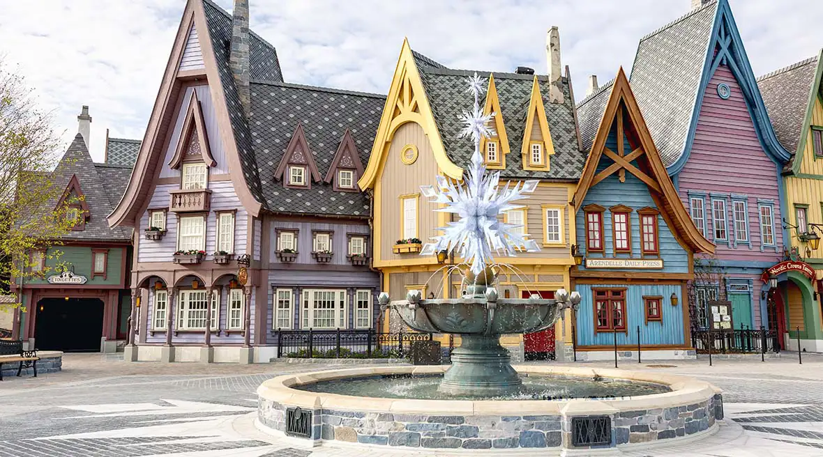 The town square of Arendelle featuring traditional Scandinavian-style architecture and the iconic snowflake fountain