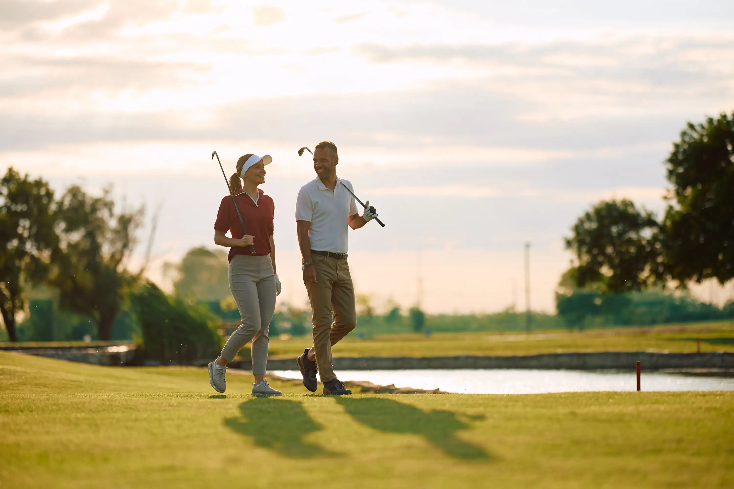 A couple looking happy playing golf