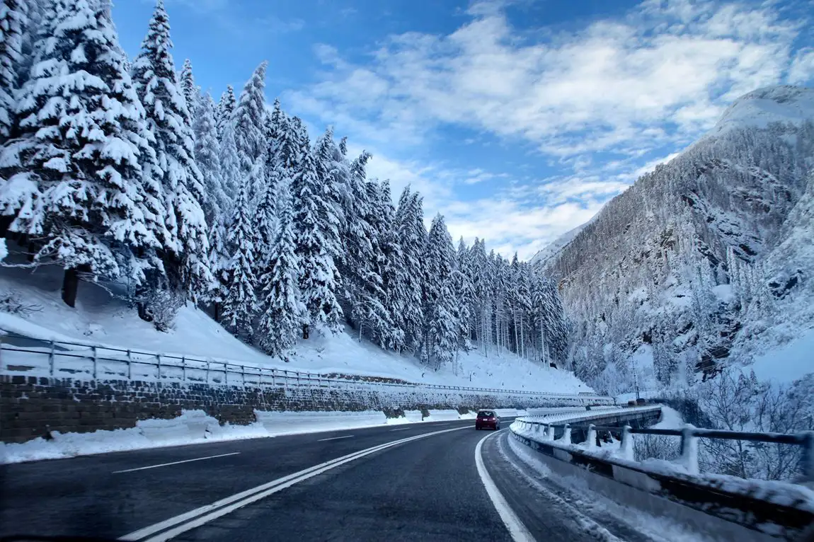 Car driving on a snowy mountain road
