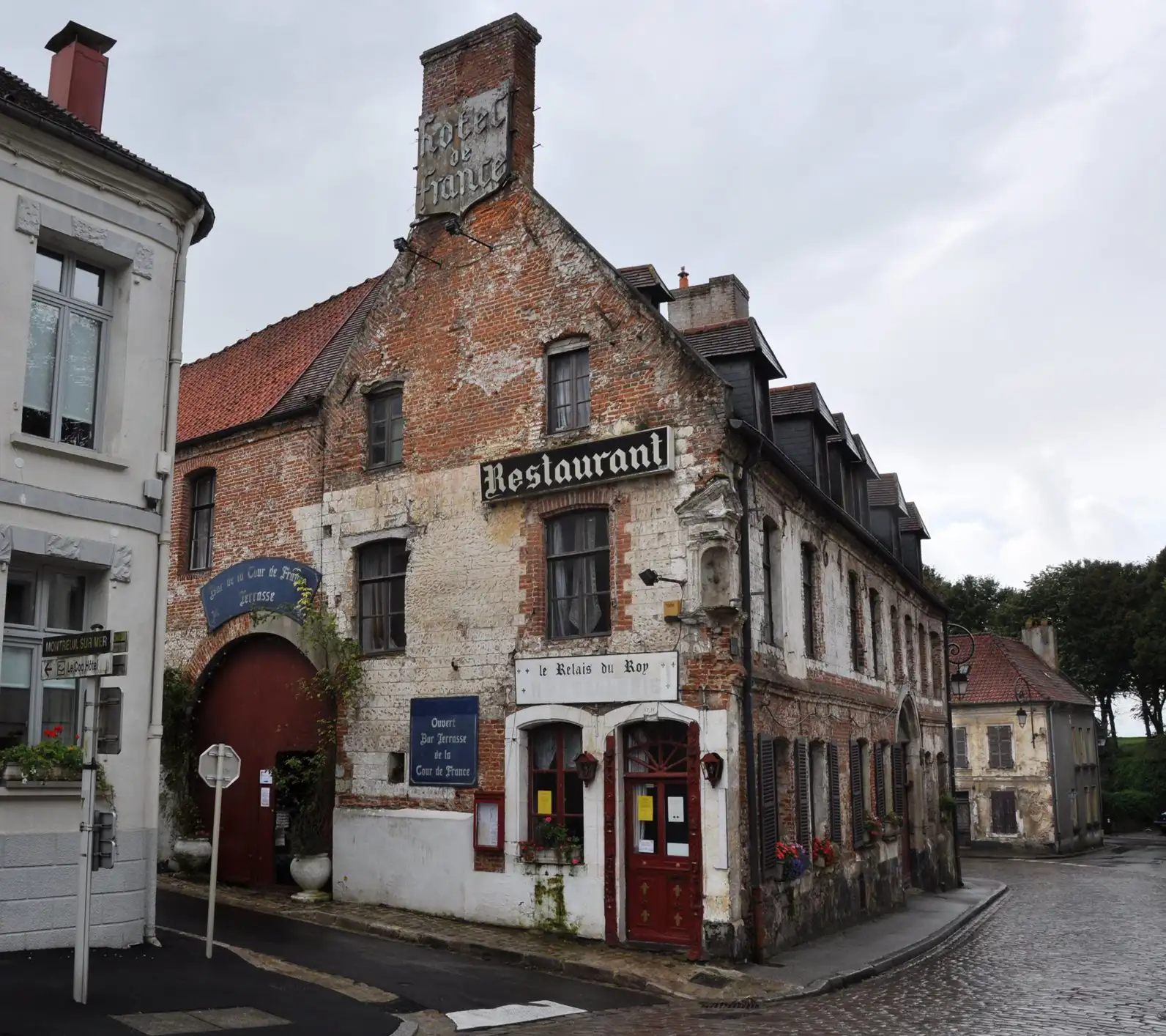 A traditional French hotel and restaurant on a cobbled street, Montreuil-sur-Mer