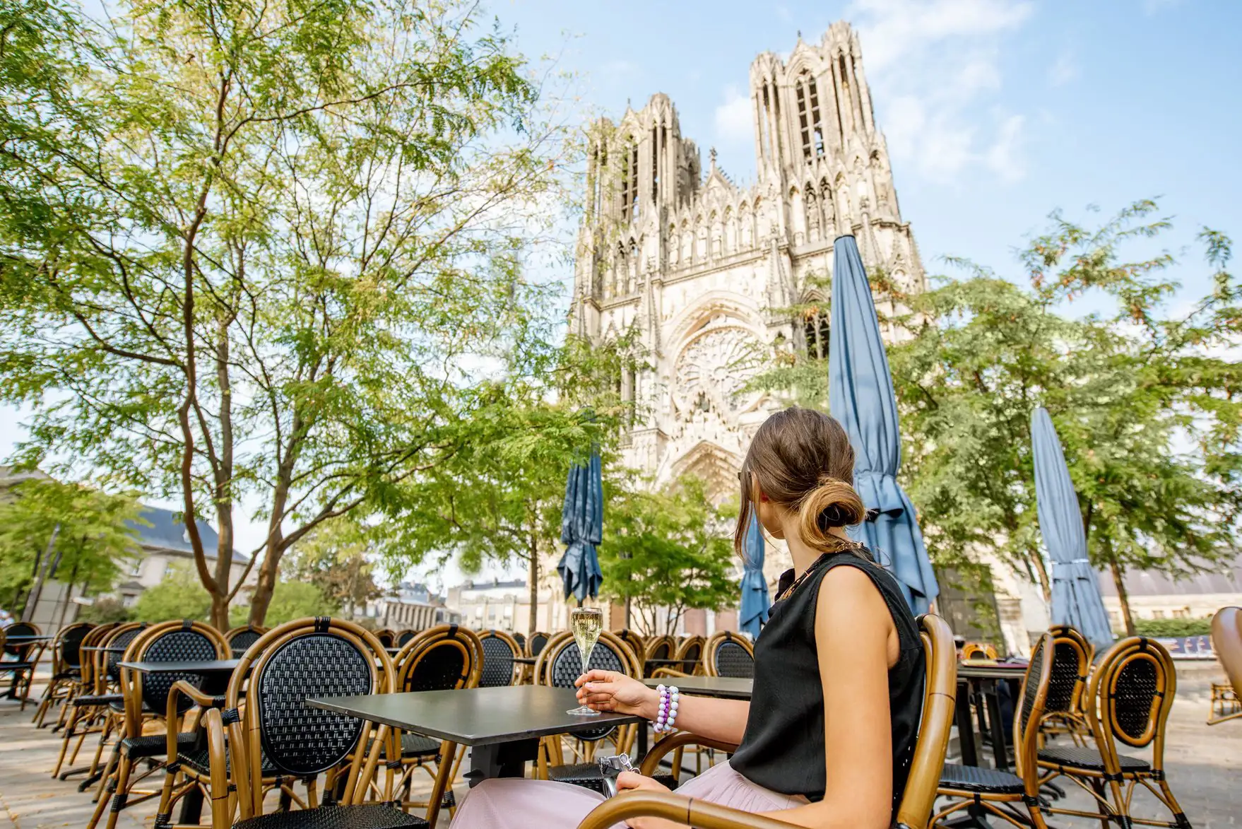 Woman with a glass of champagne in Reims, France