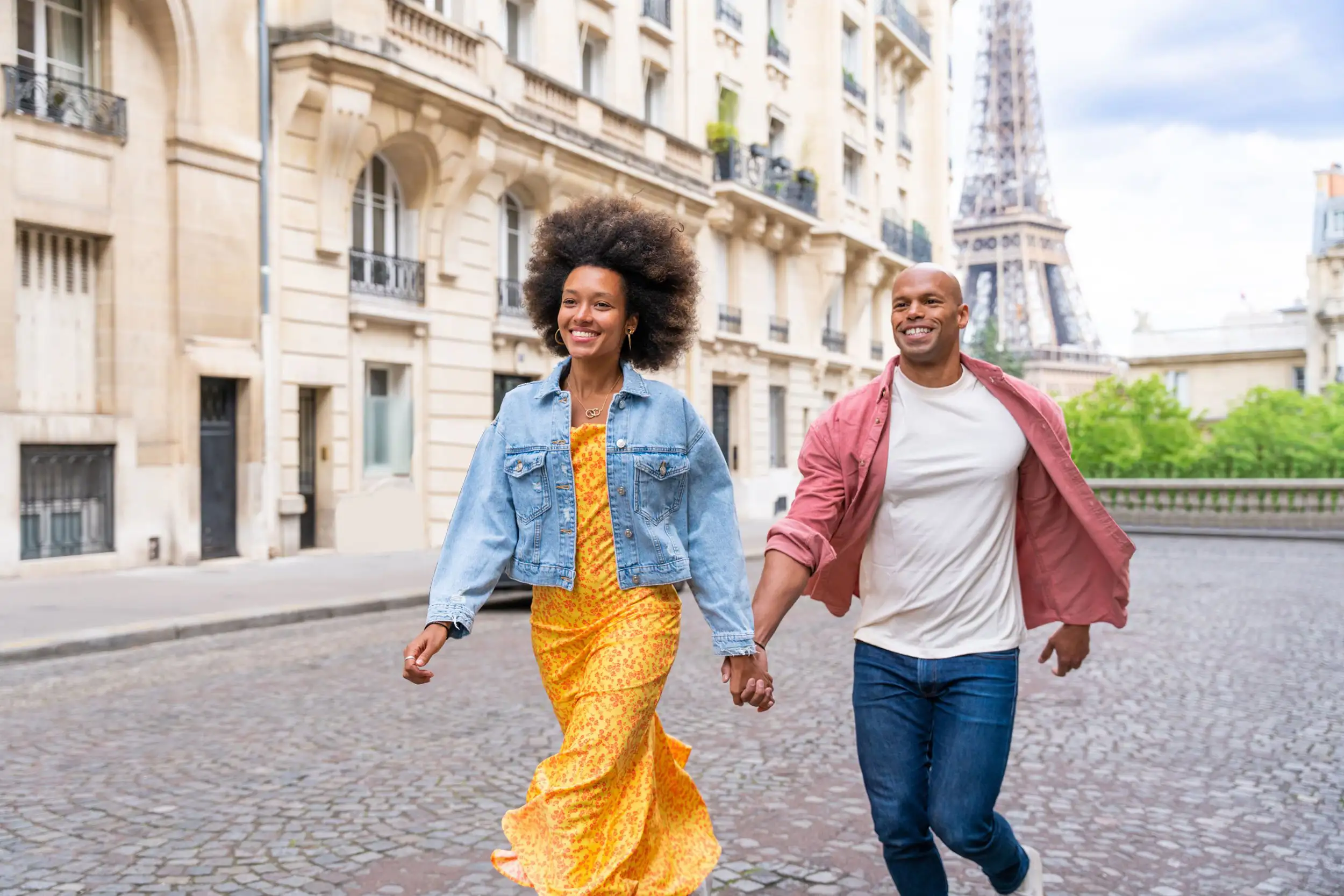 A couple holding hands in Paris