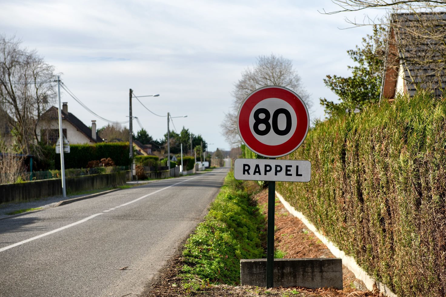 80 speed limit sign on a rural road in France