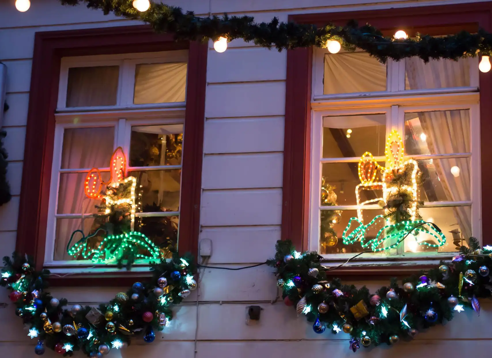 Windows illuminated with Christmas candle lights