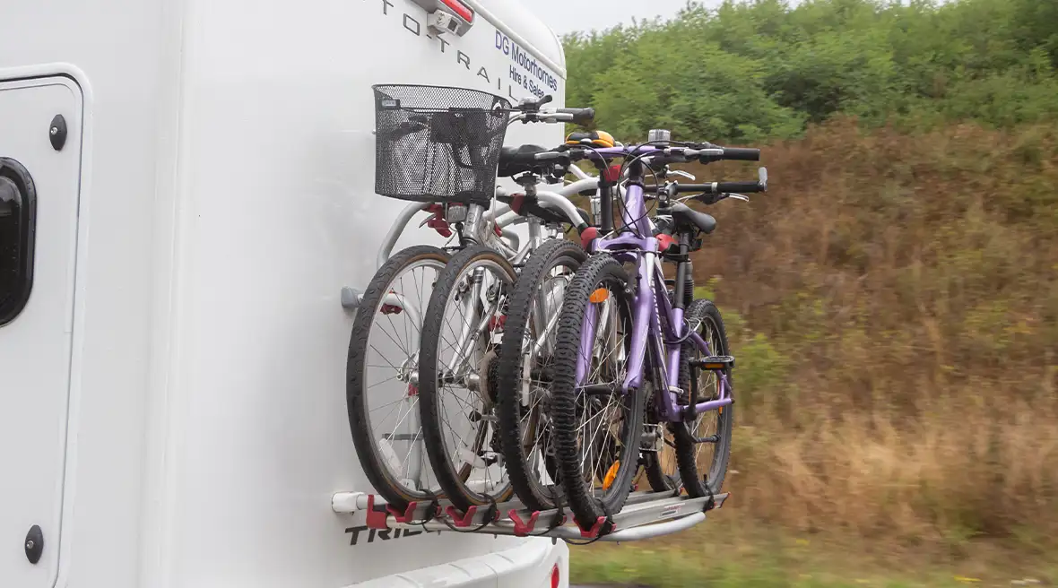 A four-bike bike rack on the back of a motorhome