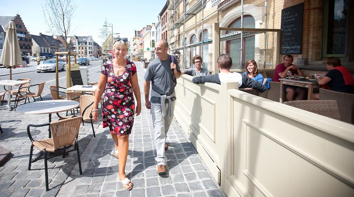 A man and a woman enjoying a stroll around Poperinge’s cobbled streets.