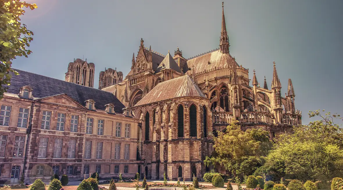 stunning French architecture cathedral building surrounded by trees under blue sky