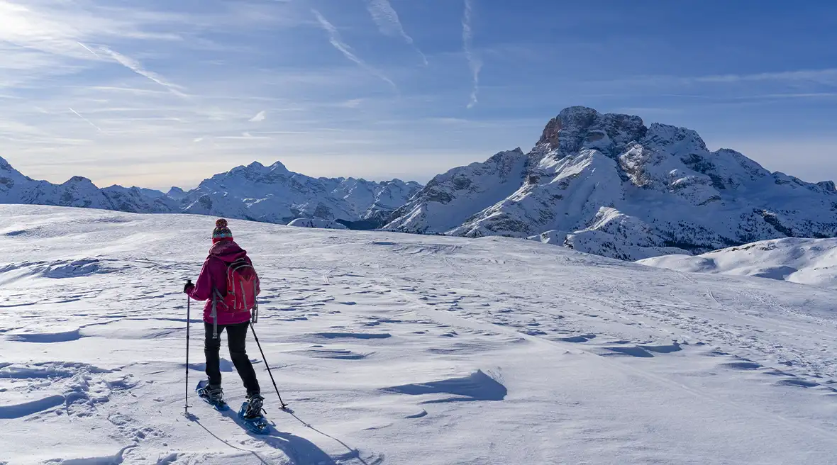 Woman hiking up the Dolomite mountains in Italy