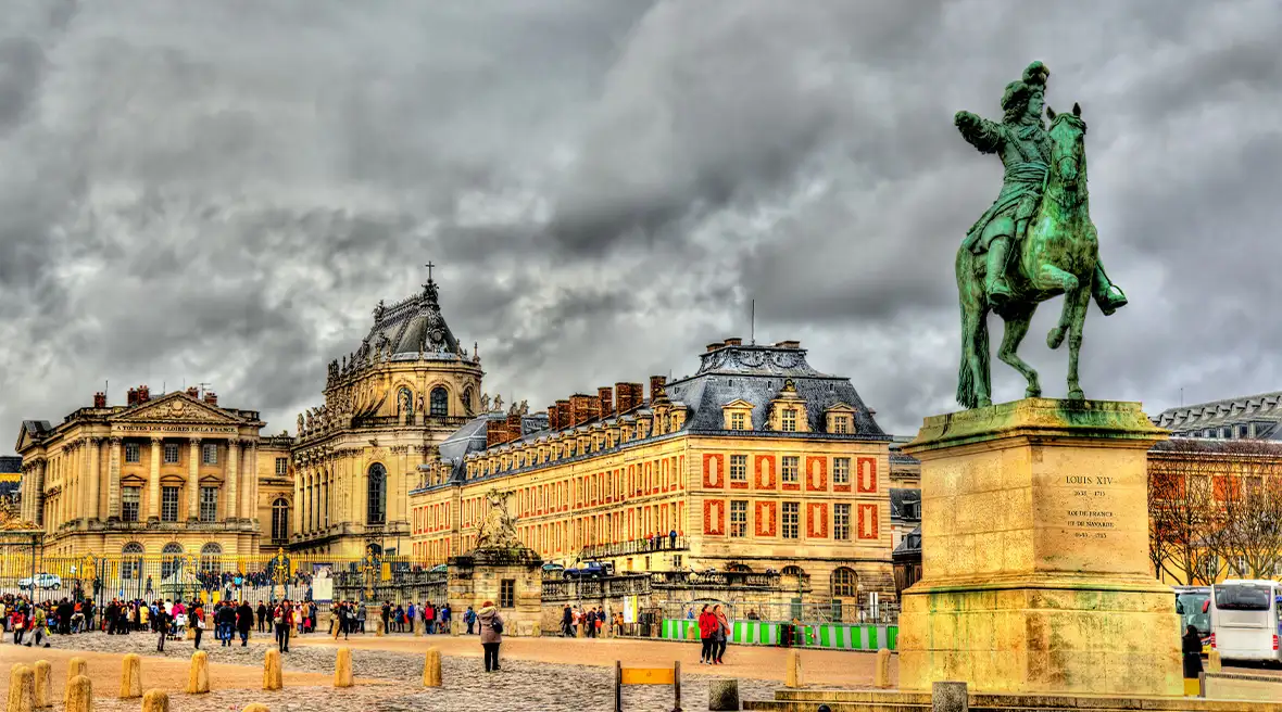 Equestrian statue in front of a grand palace building