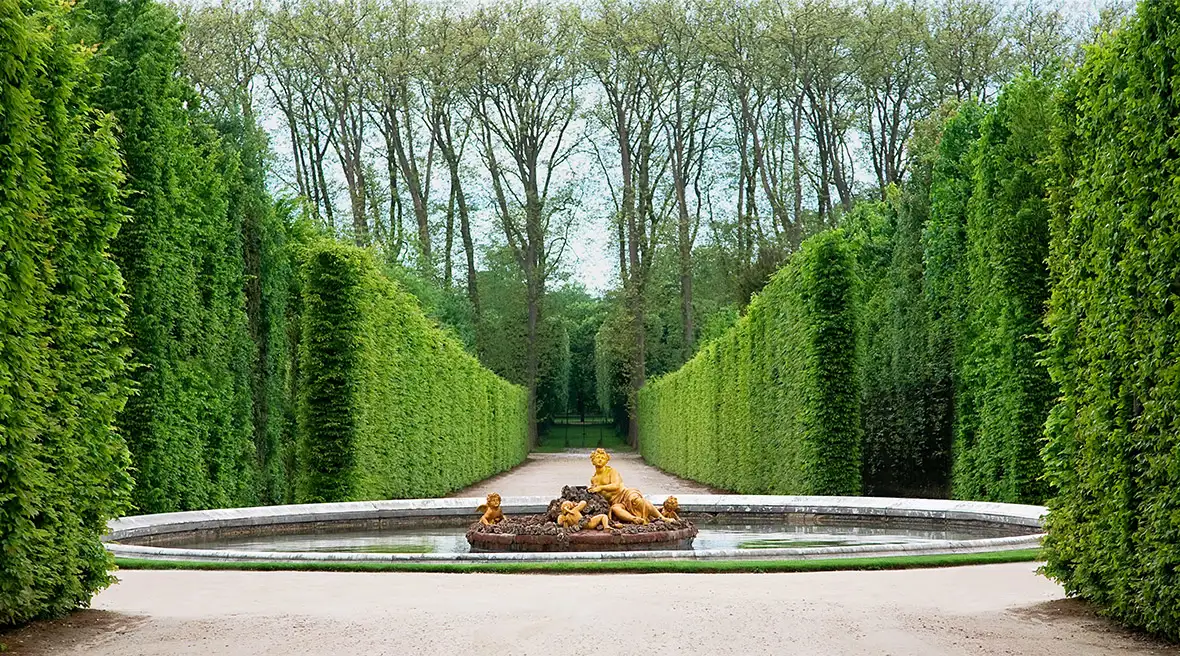 An ornamental pond with a gilded statue in a royal garden