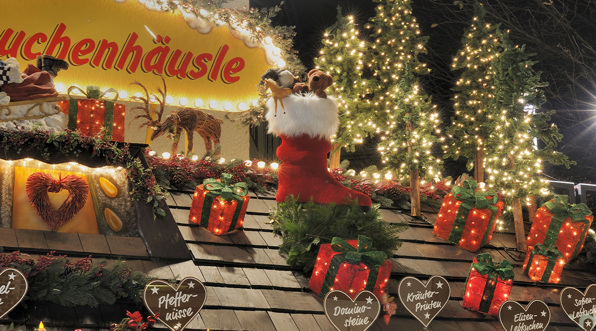 Stuttgart Christmas Market stall rooftop decorated with reindeers, a stocking filled with toys and decorated trees