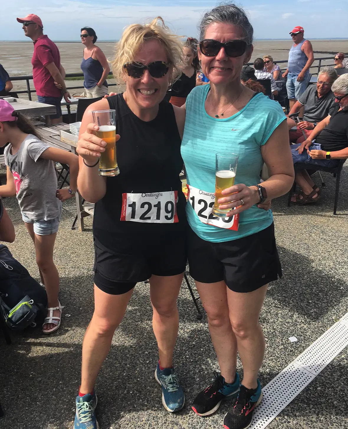 Two competitors celebrate after finishing Les Foulées du Gois running race in the Vendée