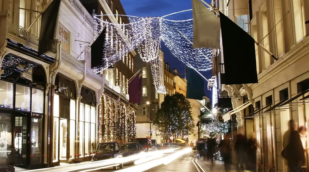 Des personnes profitent des soldes sur Bond Street illuminée par de magnifiques décorations de Noël.