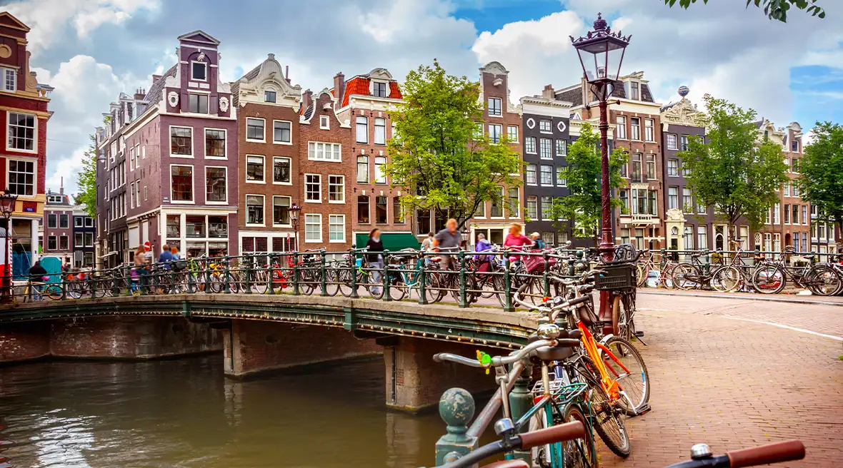 Bikes by a waterway over a hilly bridge