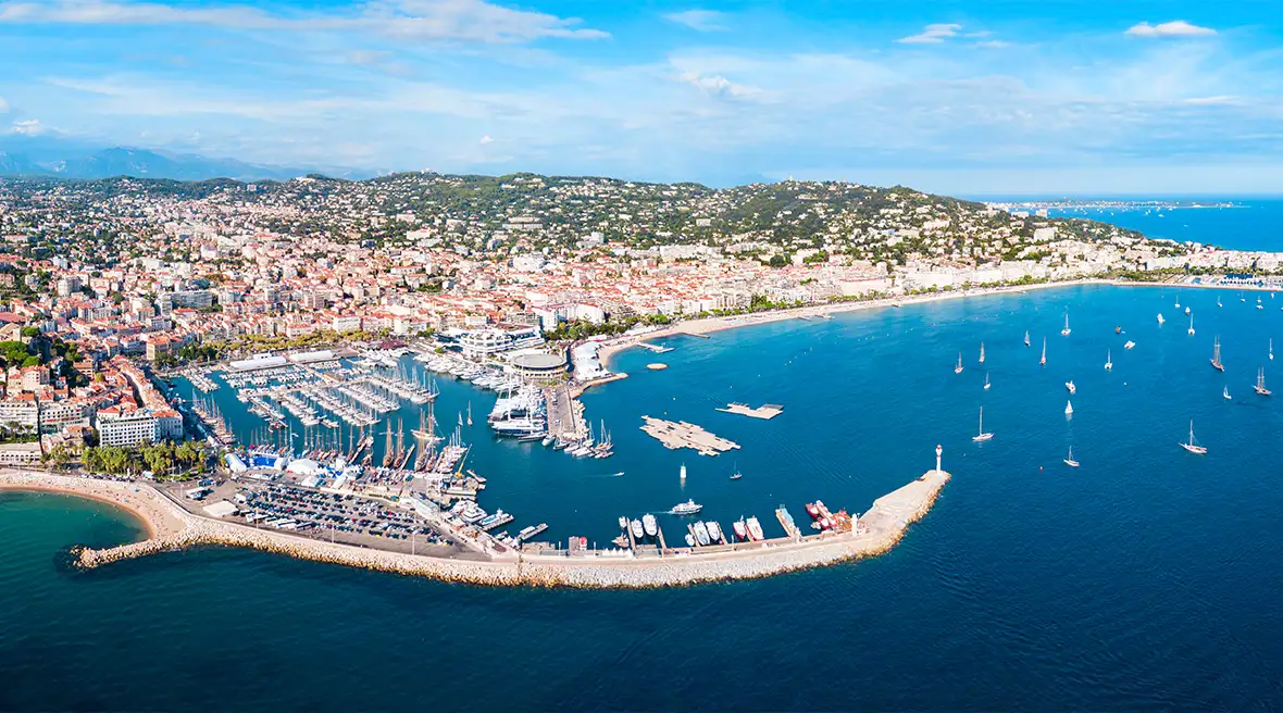 aerial view of a coastline with crystal blue water and white sandy beaches under a sunny sky