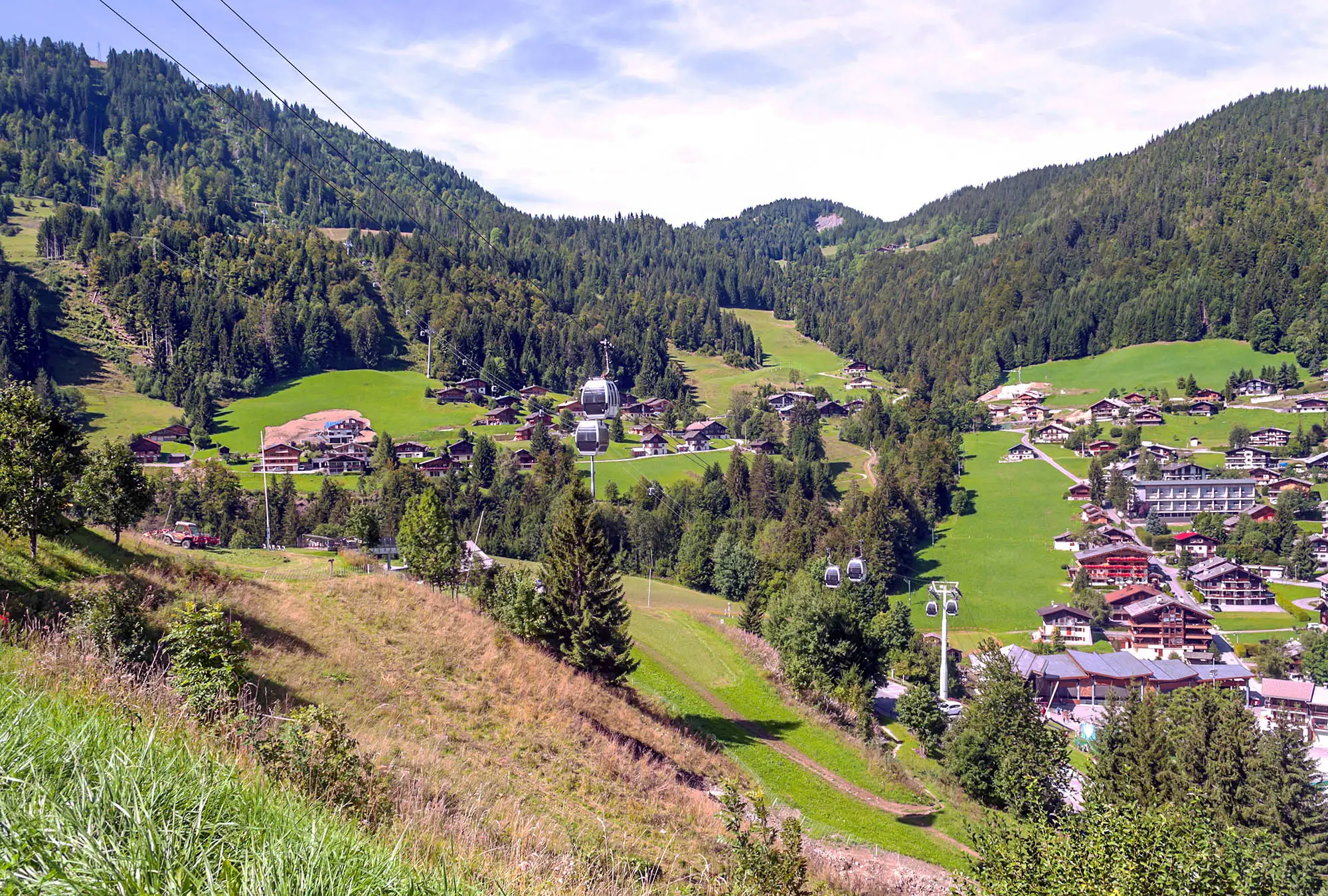 sunny day looking over an undulating mountain village in the French Alps.