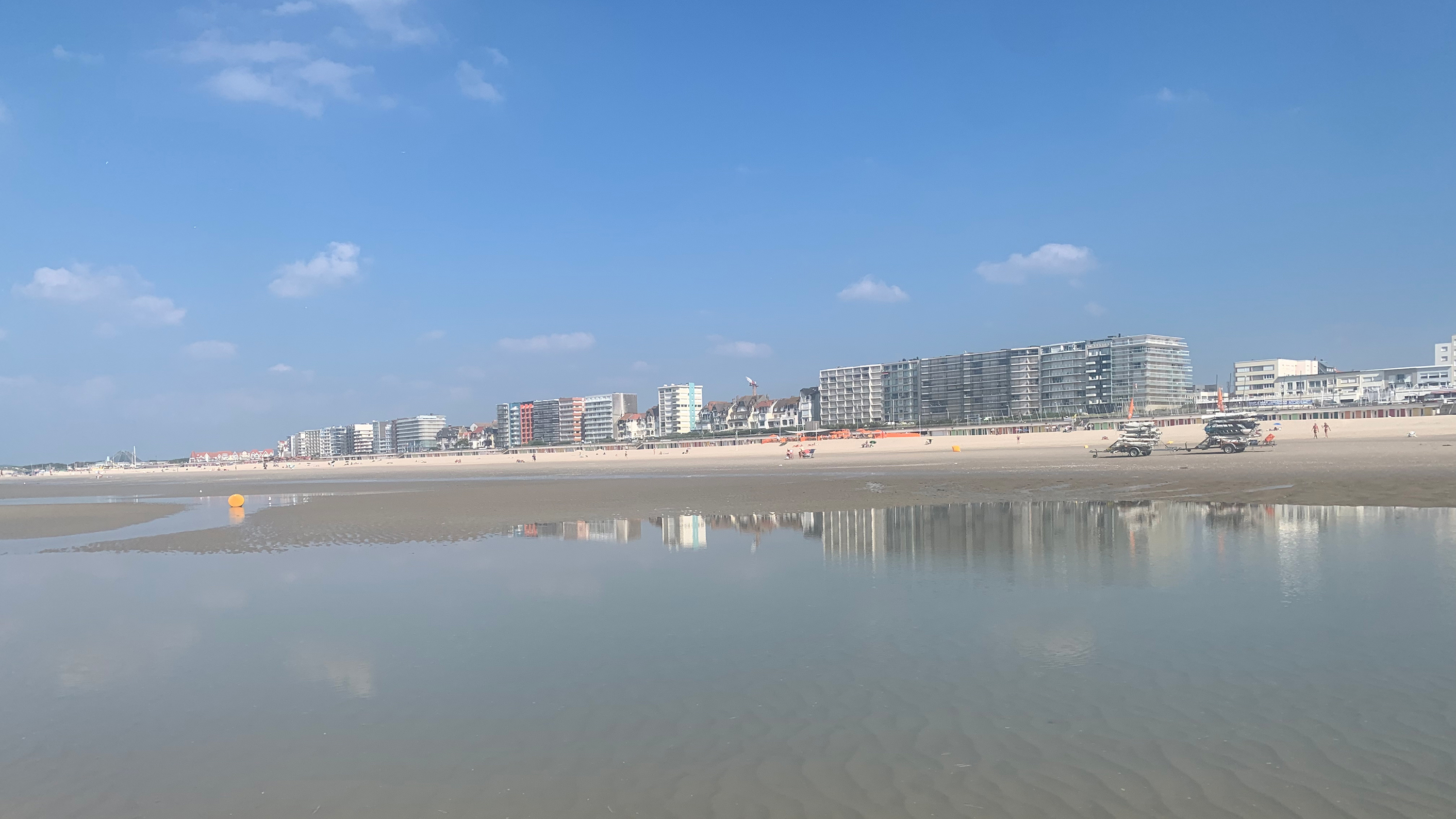 A view back at the seafront in Le Touquet, and its apartment buildings, from the beach at low tide