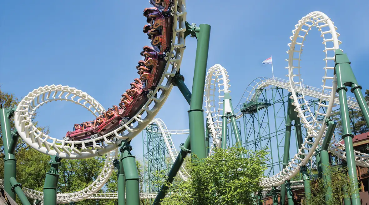 red carriages on a corkscrew rollercoaster