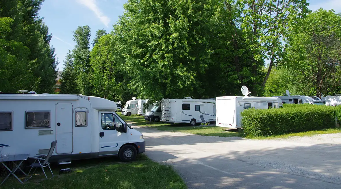 An typical French aire where vehicles are separated into pitches by waist height hedges