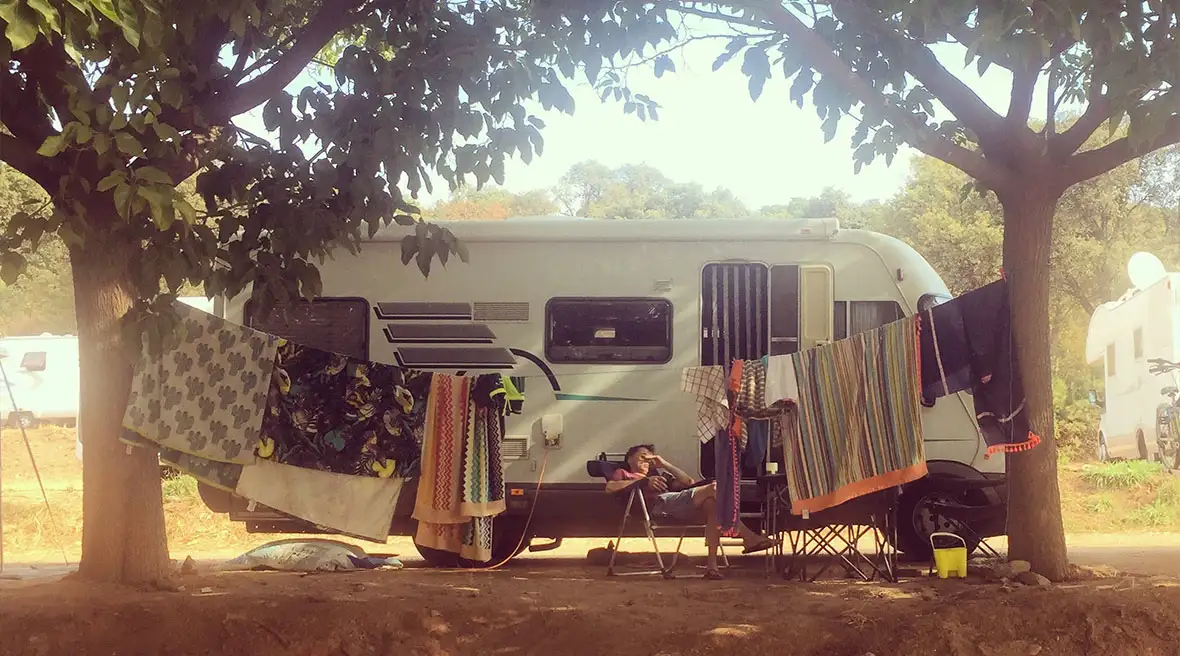 The side of a motorhome with beach towels hanging out to dry