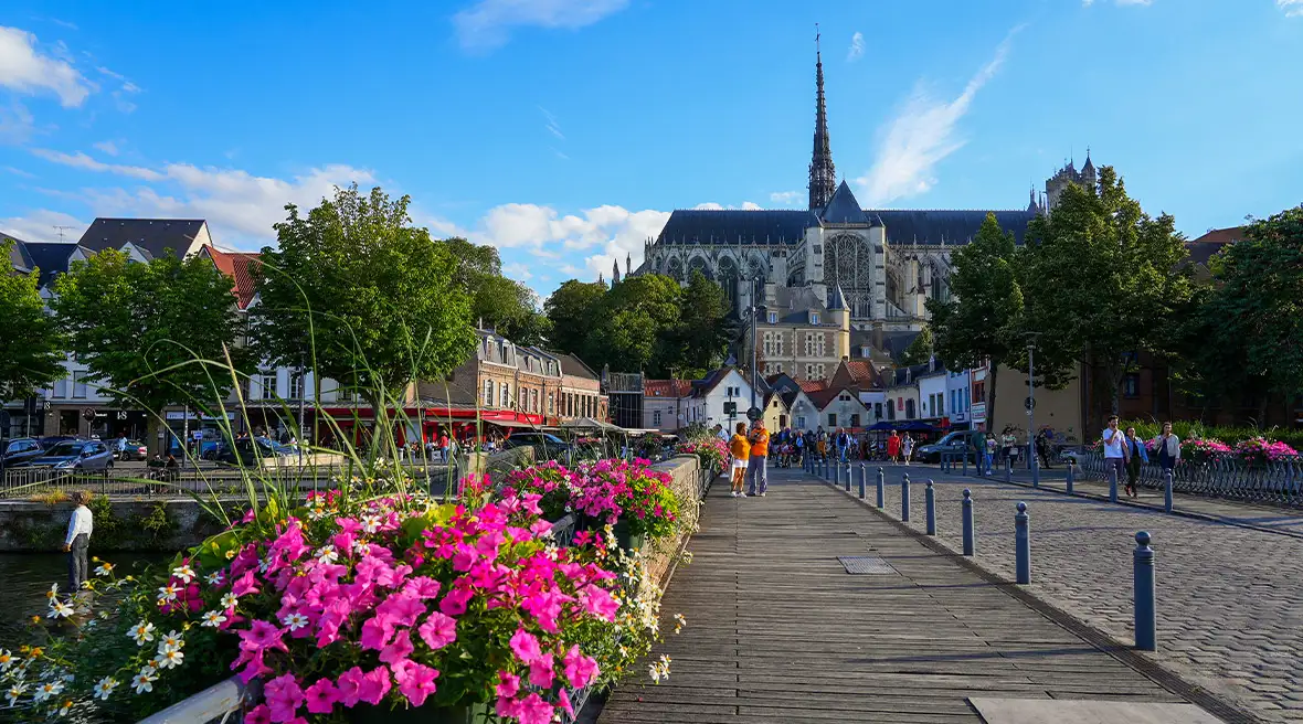 People standing in the background of bridge on the Somme river in the city center of Amiens in Picardie, France, linking the Saint Leu district with the Cathedral Square