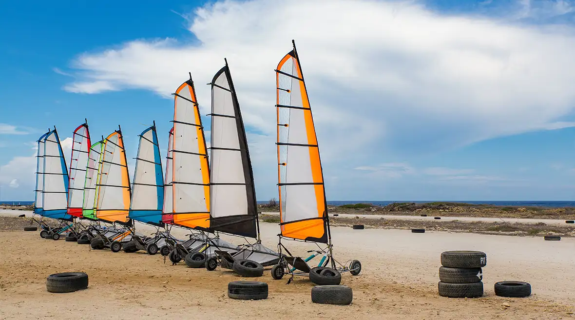Racetrack on coast with sandyachts lined up in a row