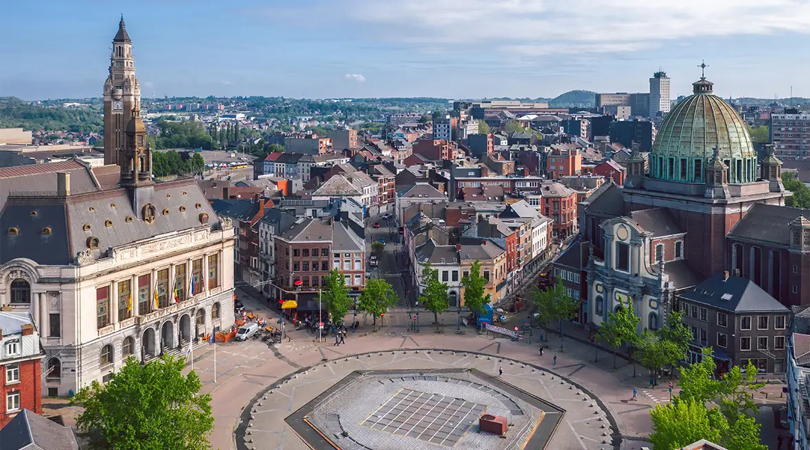 A circular city square showing a church, town hall, belfry and city streets