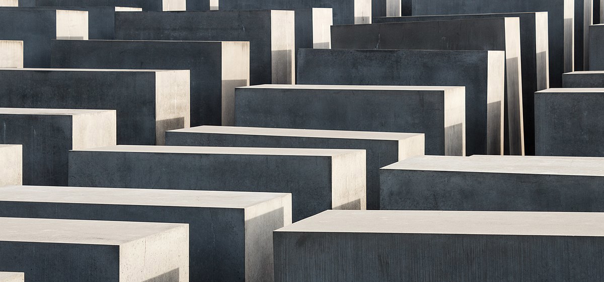 A close up of several grey concrete steles of different heights.