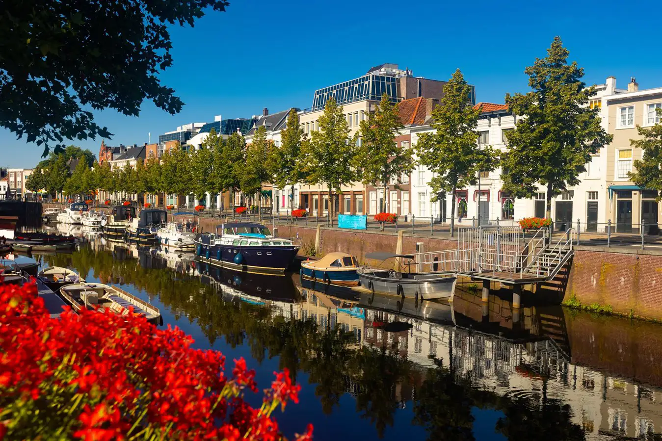 Boats moored on the banks of a canal on a perfect summer’s day