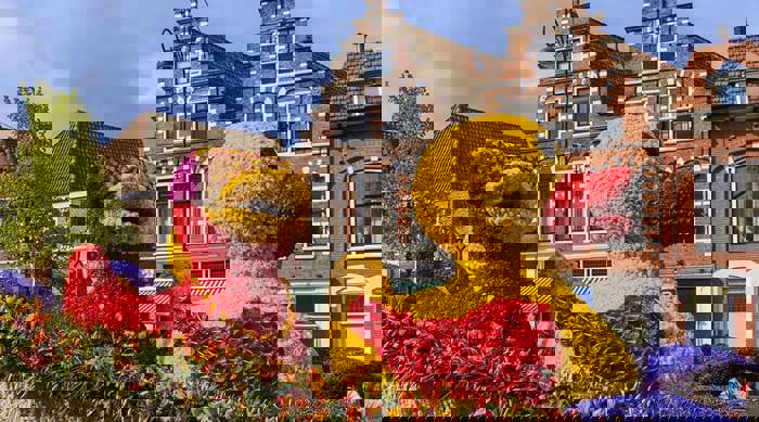 Flower parade in Haarlem featuring colourful floats with giant flower-shaped ducks, part of the annual Flower Route.