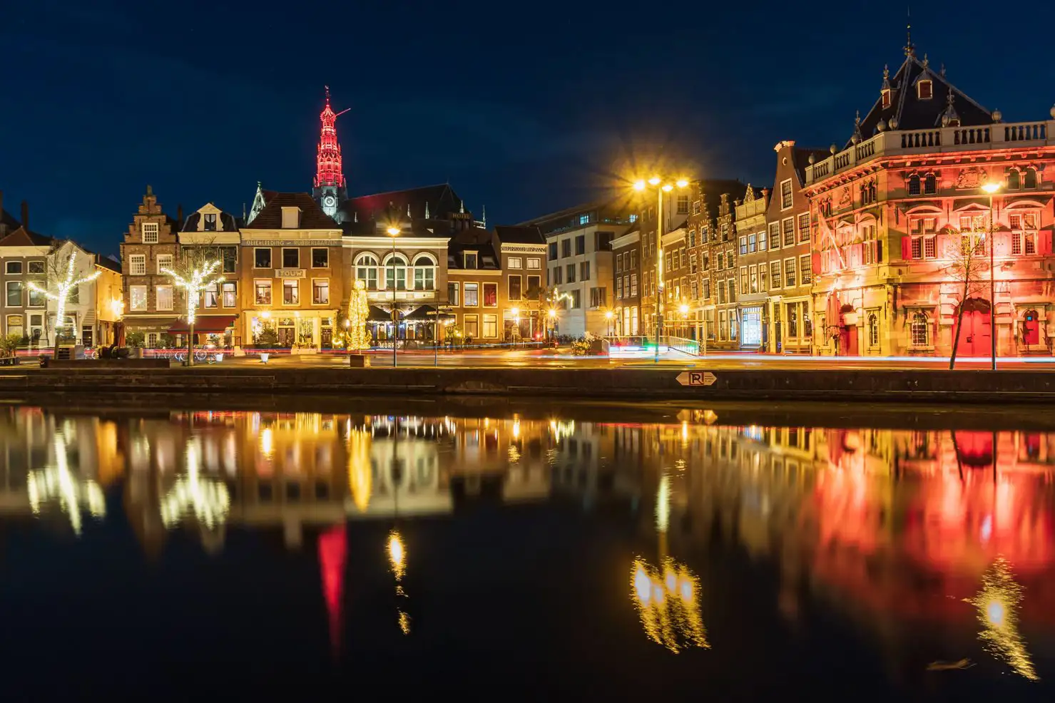 Illuminations reflect from a canal at night in Haarlem, Netherlands