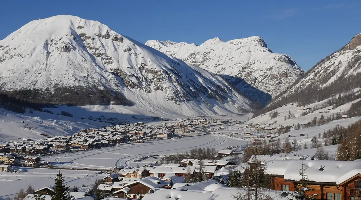 A snow-covered Alpine village in winter on a sunny day, Livigno, Italy