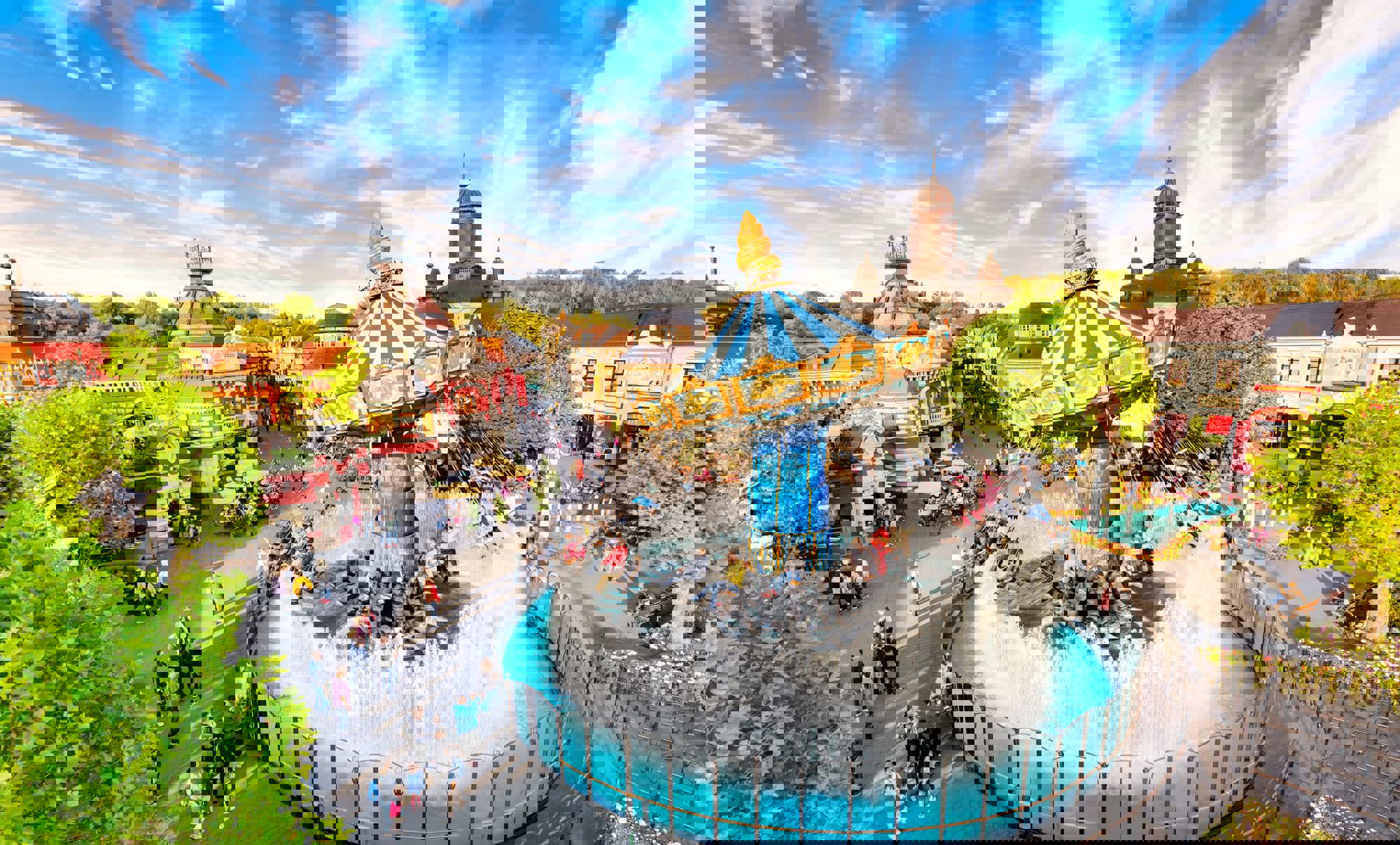 A carousel ride with a fountain below it in a theme park, Phantasialand, Germany